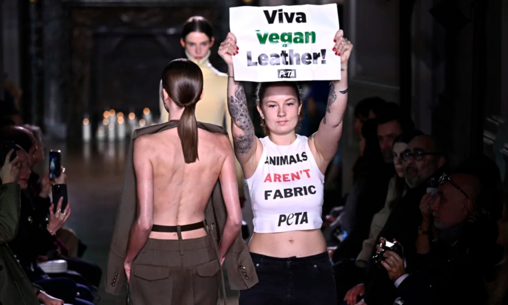 Victoria Beckham's show at Paris Fashion Week, on crutches, was disrupted by PETA protesters.