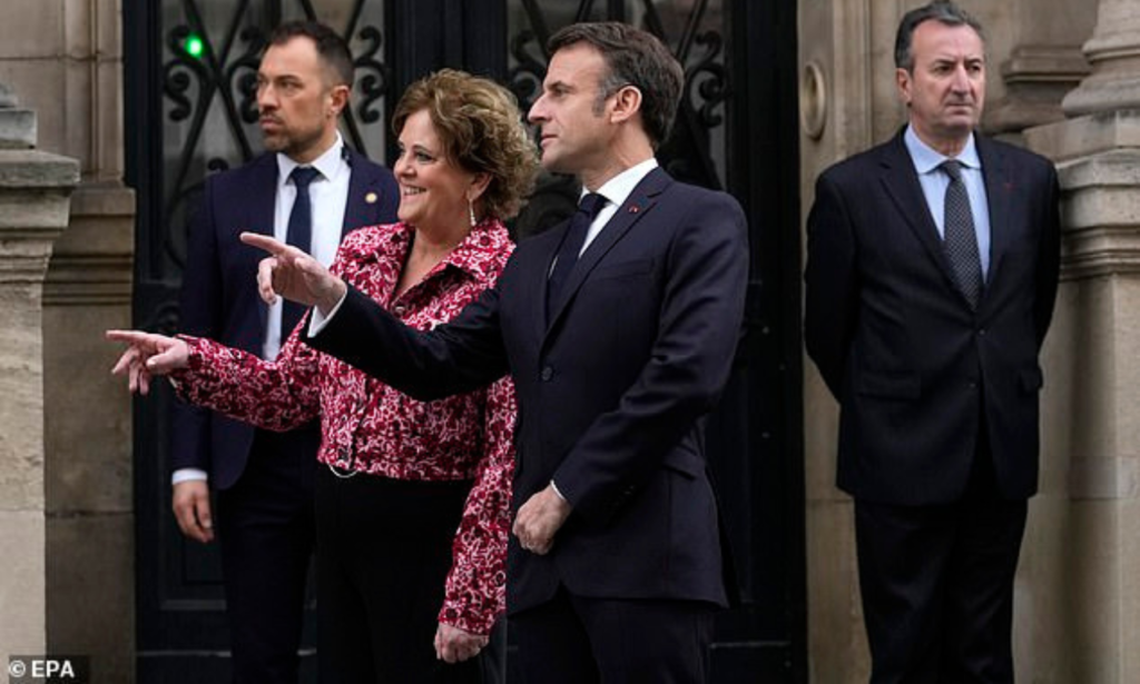 French President Emmanuel Macron and British ambassador to France Menna Rawlings gesture outside the Elysee Palace in Paris today 